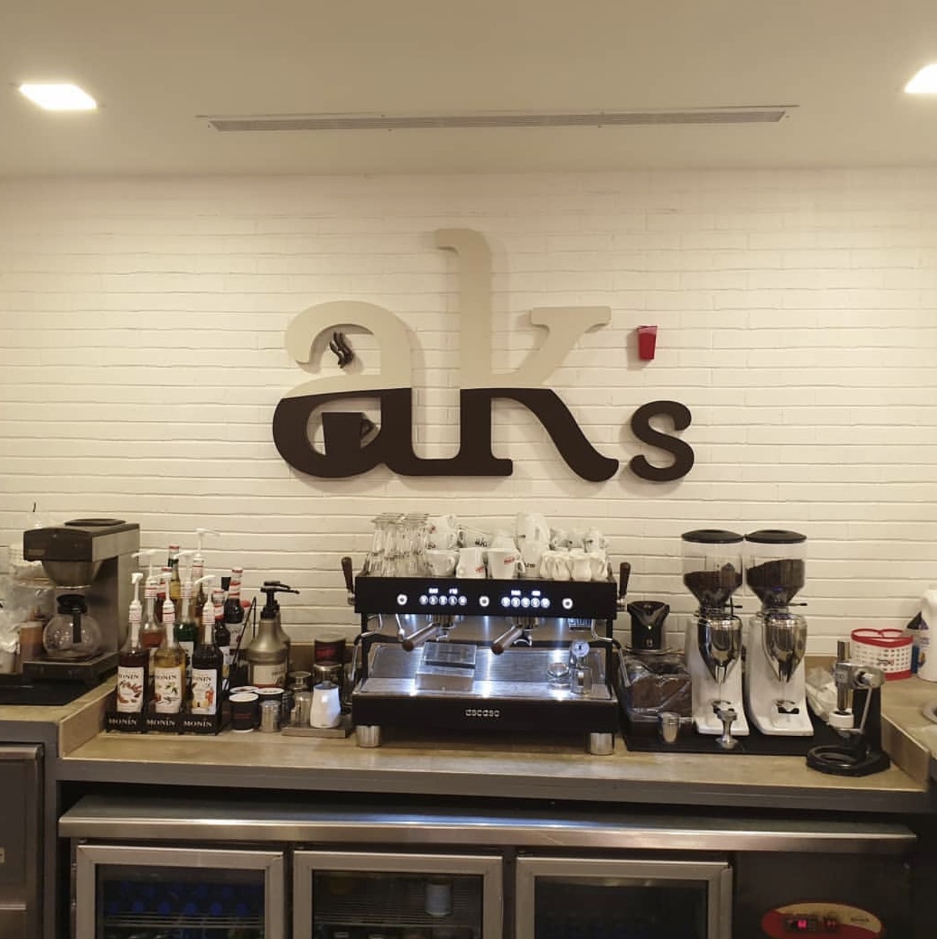 Espresso bar and AK's signage inside AK's Coffee House in Damascus